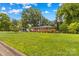 Spacious front lawn with a charming brick home and an additional outbuilding in the back at 1321 Arbor Dr, Salisbury, NC 28144