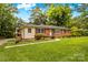 Well-maintained brick home with inviting landscaping and a cozy covered porch for relaxation at 1321 Arbor Dr, Salisbury, NC 28144