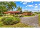 View of home with carport, back deck, gravel driveway, and landscaped yard at 1321 Arbor Dr, Salisbury, NC 28144
