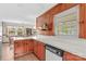 Kitchen with wood paneling, white countertops, white appliances, and view into dining room at 1321 Arbor Dr, Salisbury, NC 28144