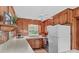A kitchen with wood paneling, a white ceiling fan, stainless steel appliances and light countertops at 1321 Arbor Dr, Salisbury, NC 28144
