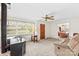 Bright living room featuring a fireplace, ceiling fan, and large windows with scenic views at 1321 Arbor Dr, Salisbury, NC 28144