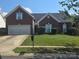 Charming brick home featuring a well-maintained lawn and a two-car garage at 13409 Planters Row Dr, Charlotte, NC 28278