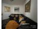 Stylish living room featuring a comfortable sectional sofa and decorative wall art at 13409 Planters Row Dr, Charlotte, NC 28278