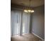 Bright dining area with sliding glass doors, neutral carpet, and an elegant chandelier at 136 Mangum Cir, Mooresville, NC 28117