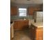 Efficient kitchen with wooden cabinets, a double basin sink, and essential appliances at 136 Mangum Cir, Mooresville, NC 28117