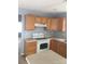 Functional kitchen with wooden cabinets, white appliances, and ample counter space at 136 Mangum Cir, Mooresville, NC 28117