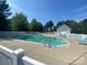 Inviting community pool surrounded by lush greenery and comfortable lounge chairs at 136 Mangum Cir, Mooresville, NC 28117