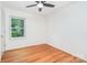 Sunny bedroom featuring hardwood floors, a ceiling fan, and large windows for natural light at 140 Fairway Ln, Gastonia, NC 28216