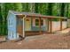 Stylish home featuring a cozy covered porch, complemented by wooded surroundings at 140 Fairway Ln, Gastonia, NC 28216
