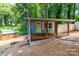 Charming home with a covered porch, wooden shed, and natural surroundings at 140 Fairway Ln, Gastonia, NC 28216