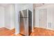 Kitchen corner showcases a stainless steel refrigerator, hardwood floors, and a white door at 140 Fairway Ln, Gastonia, NC 28216