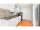 Functional kitchen featuring white cabinets, granite countertops, and stainless steel appliances at 140 Fairway Ln, Gastonia, NC 28216