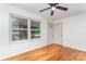 Sunlit living room with shiny hardwood floors, neutral walls, and a window overlooking green scenery at 140 Fairway Ln, Gastonia, NC 28216