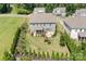 Aerial view of home with well-maintained yard and fenced-in backyard with patio and playset at 16324 Loch Raven Rd, Huntersville, NC 28078