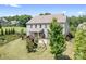 Aerial shot of backyard featuring patio, fenced yard, lush trees, and playset at 16324 Loch Raven Rd, Huntersville, NC 28078