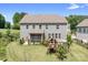 Exterior view of a two-story home with a fenced-in backyard, patio, and playground at 16324 Loch Raven Rd, Huntersville, NC 28078