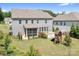 Backyard with patio, playset, mature trees, and manicured landscaping at 16324 Loch Raven Rd, Huntersville, NC 28078