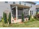 Charming backyard showing well manicured landscaping, screened porch, and hardscape patio at 16324 Loch Raven Rd, Huntersville, NC 28078