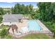 Aerial view of a pristine community pool surrounded by lounge chairs and lush trees at 16324 Loch Raven Rd, Huntersville, NC 28078