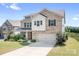 Attractive brick two-story home with a well-kept lawn and attached two-car garage at 16324 Loch Raven Rd, Huntersville, NC 28078