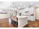 Spacious open-concept kitchen with a large island, white cabinetry, and hardwood flooring at 16324 Loch Raven Rd, Huntersville, NC 28078