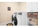Functional laundry room with side-by-side washer and dryer and ample storage space at 16324 Loch Raven Rd, Huntersville, NC 28078