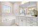 Luxurious main bathroom with a soaking tub, vanity with double sinks, and elegant fixtures at 16324 Loch Raven Rd, Huntersville, NC 28078