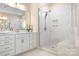 Elegant bathroom with a glass-enclosed shower, white cabinets, and marble countertops at 16324 Loch Raven Rd, Huntersville, NC 28078