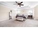 Spacious main bedroom with tray ceiling, large windows, carpet flooring, and a seating area at 16324 Loch Raven Rd, Huntersville, NC 28078