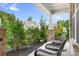 Inviting porch with comfortable seating amidst lush greenery and a serene neighborhood view at 16324 Loch Raven Rd, Huntersville, NC 28078