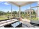 Comfortable screened porch with wicker furniture overlooks a nicely landscaped yard and open space at 16324 Loch Raven Rd, Huntersville, NC 28078