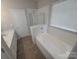 Bright bathroom featuring a bathtub with shower, and double sink vanity at 1715 Crabapple Tree Ln, Charlotte, NC 28214