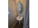 Powder room featuring a pedestal sink and oval mirror at 1715 Crabapple Tree Ln, Charlotte, NC 28214