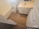 Bathroom featuring a bathtub and single sink vanity with storage at 1715 Crabapple Tree Ln, Charlotte, NC 28214