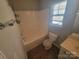 Cozy bathroom featuring a tub and shower combination, and a single sink vanity at 1715 Crabapple Tree Ln, Charlotte, NC 28214