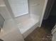 Bright bathroom with a white bathtub and a window with blinds at 1715 Crabapple Tree Ln, Charlotte, NC 28214