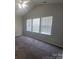 Bedroom with neutral paint, carpet, vaulted ceiling, and large windows offering ample natural light at 1715 Crabapple Tree Ln, Charlotte, NC 28214