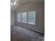 Bedroom with neutral paint, carpet, vaulted ceiling, and three large windows offering ample natural light at 1715 Crabapple Tree Ln, Charlotte, NC 28214