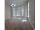 Bright dining room with neutral paint, carpet, chandelier, and large windows offering ample natural light at 1715 Crabapple Tree Ln, Charlotte, NC 28214