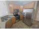 Well-equipped kitchen featuring stainless steel appliances, ample counter space, and tiled flooring at 1715 Crabapple Tree Ln, Charlotte, NC 28214