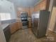 Well-equipped kitchen featuring stainless steel appliances, ample counter space, and tiled flooring at 1715 Crabapple Tree Ln, Charlotte, NC 28214