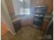 Well-equipped kitchen featuring stainless steel appliances, ample counter space, and tiled flooring at 1715 Crabapple Tree Ln, Charlotte, NC 28214