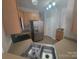 Well-equipped kitchen featuring stainless steel appliances, ample counter space, and tiled flooring at 1715 Crabapple Tree Ln, Charlotte, NC 28214