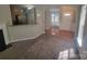 A carpeted living room features neutral paint and a partial view of kitchen, entry, and dining area at 1715 Crabapple Tree Ln, Charlotte, NC 28214