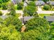 Aerial view showcasing the home's backyard with patio and fire pit, surrounded by lush trees at 1887 Steeplechase Dr, Rock Hill, SC 29732