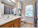 Well-lit bathroom featuring a wood vanity with white countertop and modern fixtures at 1887 Steeplechase Dr, Rock Hill, SC 29732