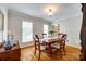 Bright dining room with hardwood floors, large windows, and a wooden table with seating for four at 1887 Steeplechase Dr, Rock Hill, SC 29732