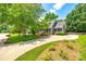 Inviting home exterior with lush landscaping, a covered porch, and a long driveway at 1887 Steeplechase Dr, Rock Hill, SC 29732