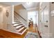 Inviting home foyer featuring hardwood floors, staircase, and view into the dining room at 1887 Steeplechase Dr, Rock Hill, SC 29732
